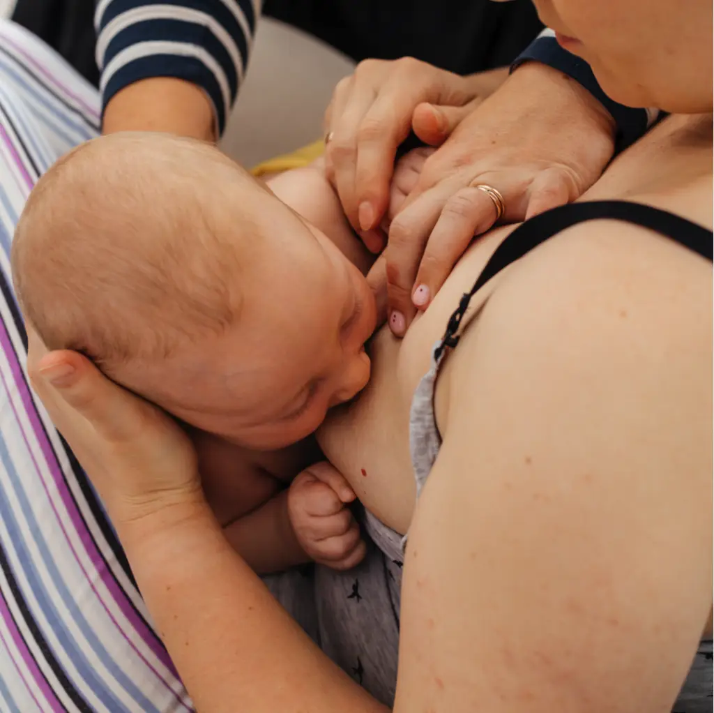 Lactation consultant Queen Creek, AZ assisting a mother with proper breastfeeding latch to ensure a comfortable and successful nursing experience – Luxe Lactation AZ.